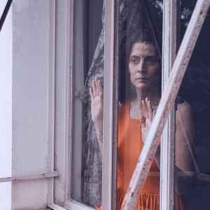 woman staring through window